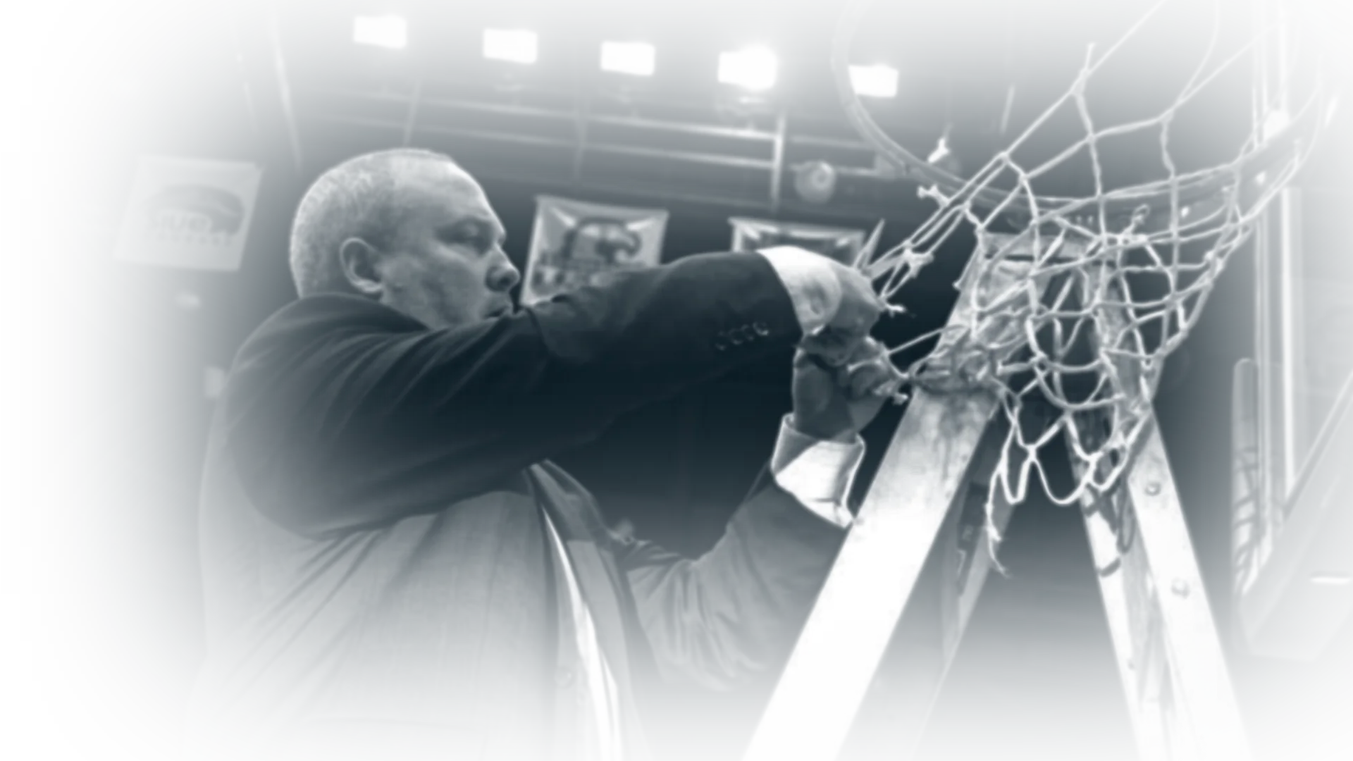 Coach Jason Mays cutting down the championship net